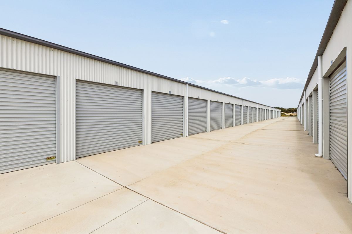 Wide concrete driveway between shed rows, SafeHouse Storage Murray Bridge
