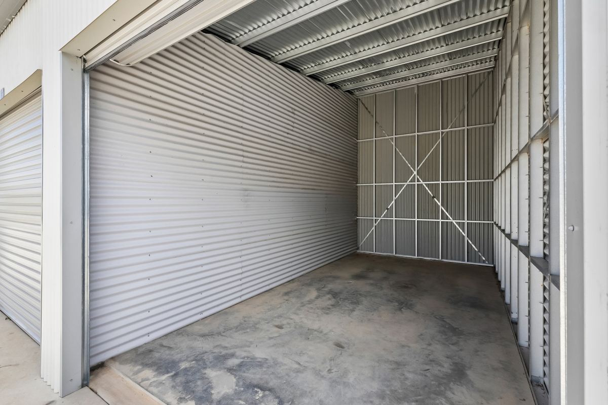 Inside an empty storage shed with the roller door open, SafeHouse Storage Murray Bridge